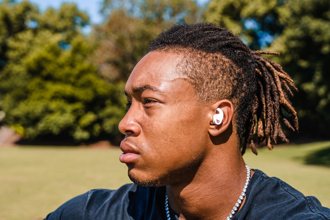 Kendall Milton posing with Beats Fit Pro earbuds